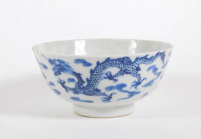 A late 19thC Chinese blue and white porcelain bowl, with four claw celestial dragon and four character mark to base, 12cm diameter. (AF - hairline crack)