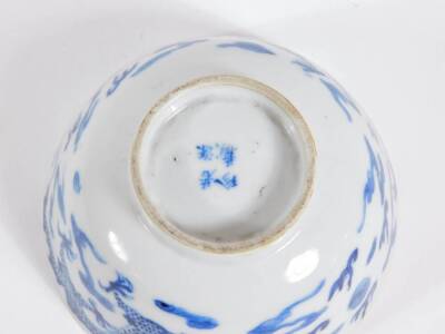 A late 19thC Chinese blue and white porcelain bowl, with four claw celestial dragon and four character mark to base, 12cm diameter. (AF - hairline crack) - 5