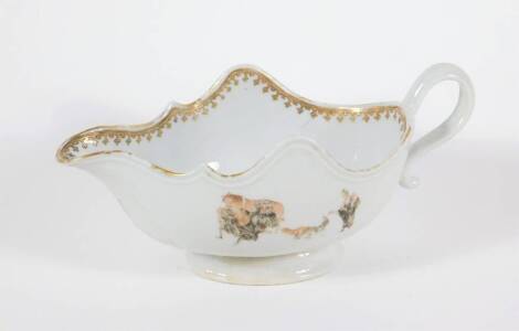 An 18thC Chinese porcelain sauce boat, the moulded body with gilt border and floral spray interior and figures with ox to the panels, 23cm wide.