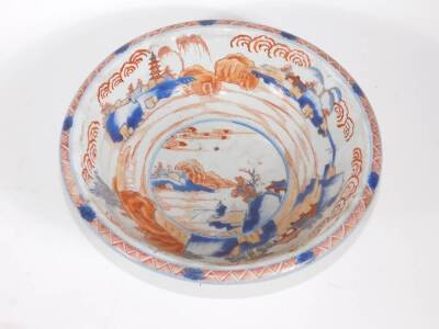 An 18thC Chinese porcelain bowl, with landscape and fisherman in central reserve in Imari colours, 26cm diameter. (AF - two losses to underside of the rim and hairline crack to body) - 2