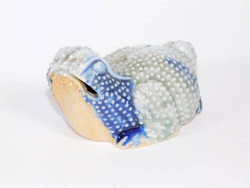 A 19thC Oriental celadon and blue glazed figure of a toad, 13cm long.