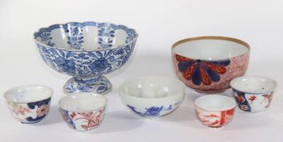 Six various 18th and 19thC Japanese porcelain bowls, and a Chinese blue and white stem cup wit scrolling peony designs, 15cm diameter down.