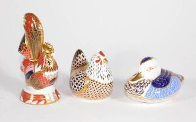 Three Royal Crown Derby paperweights, comprising of a duck, chicken and cockerel.