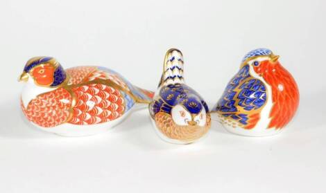 Three Royal Crown Derby paperweights, including robin and pheasant.