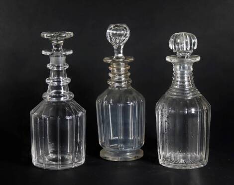 Three Georgian mallet shaped glass decanters, with ring necks and cut bodies, all with stoppers, 23.5cm high and 22.5cm high. (3)