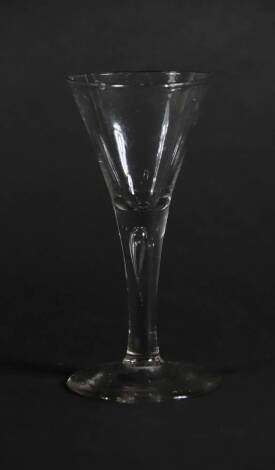 An 18thC wine glass, with trumpet bowl and tapered air stem, 16.5cm high.