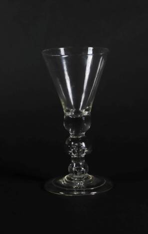 An 18thC wine glass, the plain thistle bowl with solid base and air mushroom knop to the stem, on a folded foot, 17cm high.