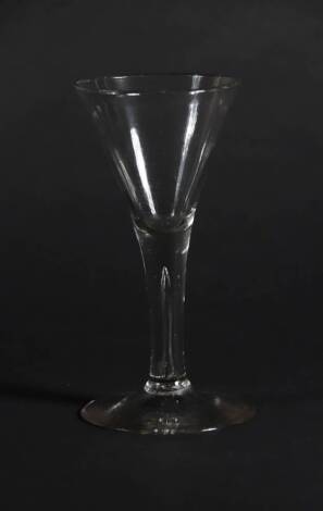 An 18thC wine glass, with trumpet bowl and tapered air stem, 16.9cm high.