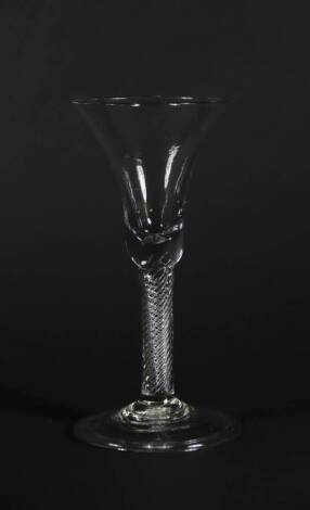 An 18thC wine glass, with bell shaped bowl and air twist stem on a folded foot, 18.8cm high.