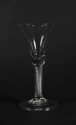 An 18thC wine glass, with bell shaped bowl and air twist stem on a folded foot, 18.8cm high.