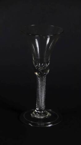 An 18thC wine glass, with bell shaped bowl and air twist stem on a folded foot, 18.5cm high.