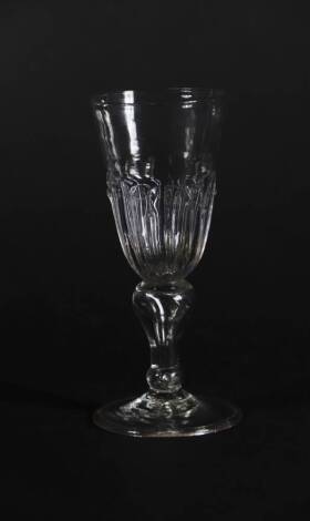 A late 17thC wine glass, with spiked gadrooning to the bowl and inverted air baluster stem on a folded foot, 14.5cm high.