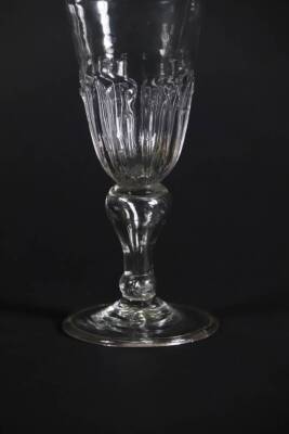 A late 17thC wine glass, with spiked gadrooning to the bowl and inverted air baluster stem on a folded foot, 14.5cm high. - 2