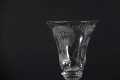 A pair of mid 18thC Jacobite wine glasses, with engraved thistle bowls, each having a white rose and buds and inscribed 'Redeat' with a star, on double knopped air twist stems, 14.7cm and 15cm high. - 6