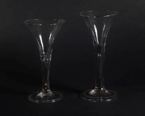 Two 18thC wine glasses, with trumpet bowls and air bubble stems, with folded feet, 18cm and 16.5cm high.