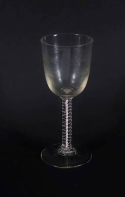 A large 18thC wine glass, with round funnel bowl on a double opaque twist stem, 21cm high.