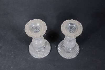 A pair of Regency cut glass candlesticks, with double knopped and ring stems, with hobnail cut decoration, raised on circular stepped feet with hobnail cut bases, lacking lustre drops, 17cm high. - 2