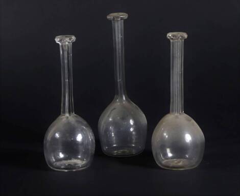 Three 19thC glass toddy lifters, including two of similar design with faceted finger stop terminals and hexagonal stems, with plain bodies and another plain toddy lifter, 14cm and 15.5cm respectively.