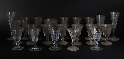 A selection of 19thC sliver cut glass wine and champagne flutes, a rummer and a deception glass with knopped stem. (21)