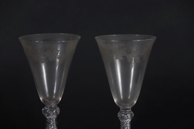 A pair of early 19thC wine glasses with trumpet shaped bowls, each engraved with a band of fruiting vine decoration, on double knopped air twist stems, and plain circular feet, 18.5cm high. - 3