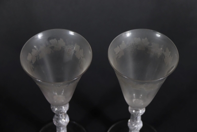 A pair of early 19thC wine glasses with trumpet shaped bowls, each engraved with a band of fruiting vine decoration, on double knopped air twist stems, and plain circular feet, 18.5cm high. - 4