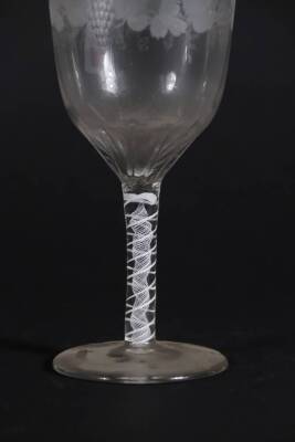 A 18thC glass wine goblet, with semi fluted bowl engraved with a band of fruiting vine decoration, and with an opaque twisted stem, on a plain circular foot, 18cm high. - 2