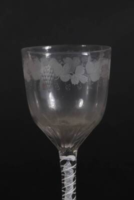 A 18thC glass wine goblet, with semi fluted bowl engraved with a band of fruiting vine decoration, and with an opaque twisted stem, on a plain circular foot, 18cm high. - 3