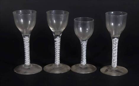 Four similar 18thC wine glasses, with plain bowls and double opaque twisted stems, raised on circular feet, ranging from 12.5cm to 14.2cm high.