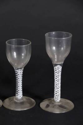 Four similar 18thC wine glasses, with plain bowls and double opaque twisted stems, raised on circular feet, ranging from 12.5cm to 14.2cm high. - 3