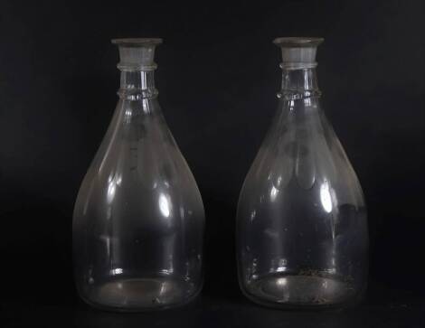 A pair of Regency ring necked mallet shaped decanters, with slice cut shoulders, 27cm high.