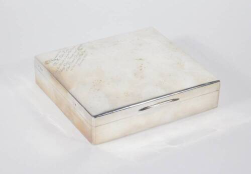 An Edwardian silver table cigarette box, of plain slightly domed rectangular design with hinged lid inscribed 'Presented to N E Little Esq by Members of Old Cleave Village Club...January 1929', London 1905, 18cm x 16cm x 4cm.