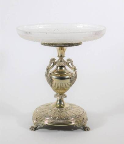 An Edwardian silver plated comport stand, of Neo Classical design with semi-fluted baluster column having peacock heads, the circular base raised on three claw feet, stamped H W & Co, supporting a cut and frosted glass circular dish, 21cm diameter, 24cm h