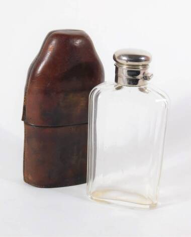 A Victorian cut glass flask, with silver plated bayonet cap, in a leather case.