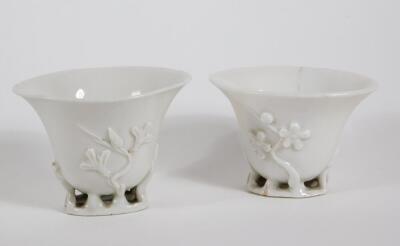 A pair of 18th/19thC Chinese Blanc De Chine libation cups, moulded with open work naturalistic bases, 7cm high. (1 AF)