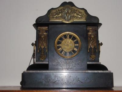 A late 19thC polished slate and marble mantel clock of architectural form