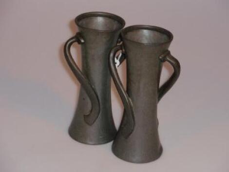 A pair of Liberty and Co Tudric hammered pewter two handled vases