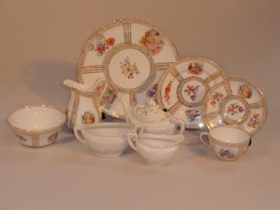 An early 20thC porcelain tea service in Dresden style together with a three