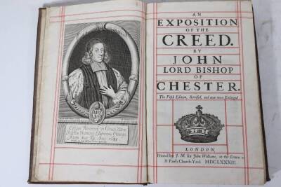 John (Chester, Lord Bishop) AN EXPOSITION OF THE CREED... fifth edition, woodcut title vignette and historiated initials, title ruled in red and black, contemporary panelled calf, large tear to top board, folio, J. M., 1676. - 2