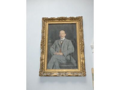 Reginald Grenville Eves (1876-1941). A portrait of Ernest Knightly Little in a seated three quarter length pose wearing a grey suit and bow tie, oil on canvas, signed and dated 1910, 116cm x 72cm. - 2