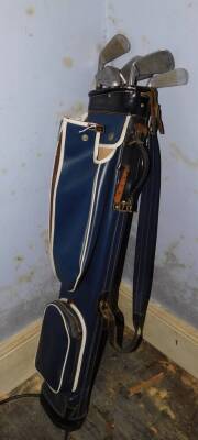 A golf club and golf bags, including three Slazenger irons, a Dunlop putter, and others.