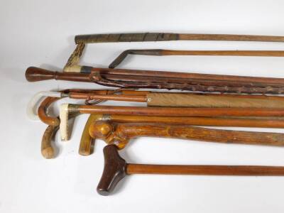 Two Malacca cane walking sticks, one with an ivory handle, other walking sticks and two hickory shafted golf clubs, etc. (12)