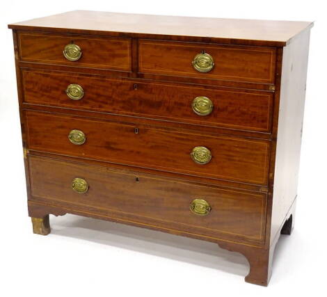 An early 19thC mahogany and boxwood strung chest of drawers, with plain top above two short and three long drawers, with oval brass handles and bracket feet, 92cm high, 109cm wide, 53cm deep.