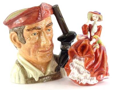 A Royal Doulton porcelain figure, from the Pretty Ladies Best of Classics Series, Top O' The Hill, and a large character jug of The Blacksmith. (2)