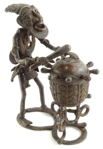 An African bronzed metal sculpture, modelled in the form of a drummer with his drum, 28cm high.