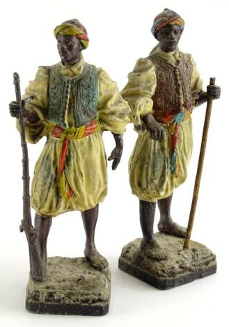 A pair of continental cold spelter figures , each modelled in the form of Arab or Moorish soldiers (AF), 23cm high.