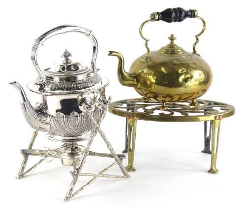 A silver plated spirit kettle, with part fluted body, the stand decorated with stylised branches, etc., (AF), 31cm high, and a Victorian brass kettle with turned handle, and a trivet. (3)