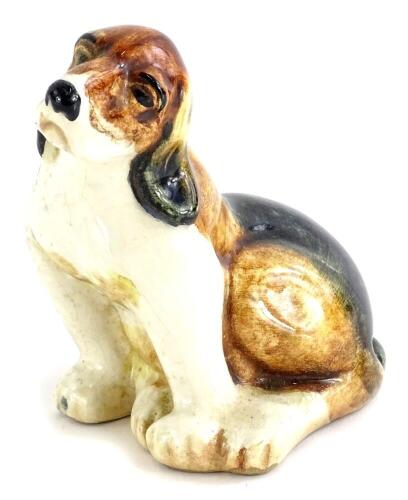 A mid 20thC pottery model of a Beagle, handwritten number 8 to underside, no factory mark, 10cm high.