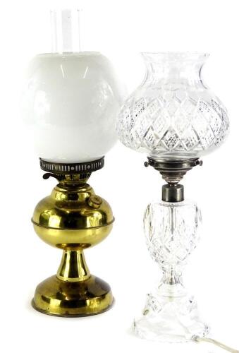 A cut glass table lamp, with thistle shaped shade and silver plated mounts, 46cm high, and a brass oil lamp, converted to electricity.