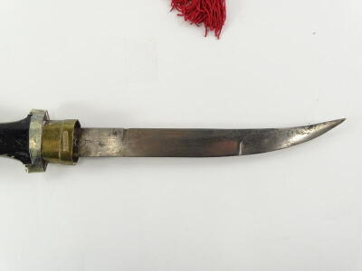 A Malayan Kris, with hardwood and silver coloured metal, scabbard, elaborately shaped blade and wooden handle, 46cm long, and an Eastern dagger, with a brass and silver coloured metal curved scabbard, stained wooden handle, etc., the blade stamped 5, 45cm - 4