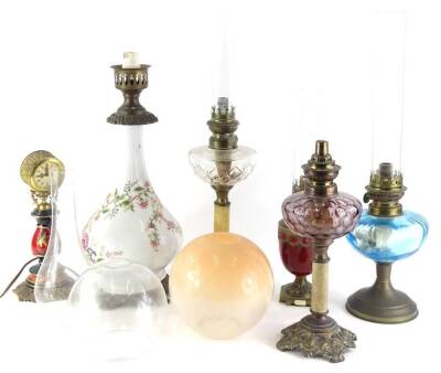 A collection of lighting, to include two column oil lamps, continental clock, etc. (6)